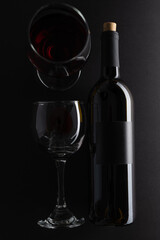 Bottle and glasses with red wine on dark grey background. Wine banner. Space for text. Template concept for your design and advertising company.