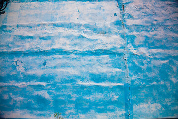 Vintage painted factory wall. Blue and white. Abstract background.