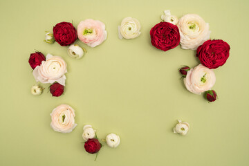 Red roses and ranunculus fresh floral flat lay with copy space