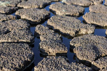 Part of a huge area of dried land suffering from drought in cracks..