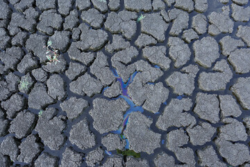 Part of a huge area of dried land suffering from drought in cracks..