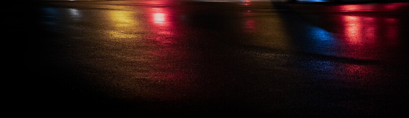 Wet asphalt, night view, neon reflection on the concrete floor. Night empty stage. Dark abstract background, dark street. Night city after rain, wet surface. Blurred background, night bokeh.