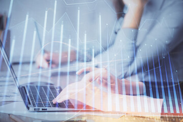 Multi exposure of woman hands typing on computer and financial chart hologram drawing. Stock market analysis concept.