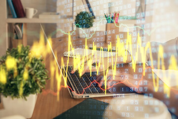 Double exposure of woman hands typing on computer and forex chart hologram drawing. Stock market invest concept.