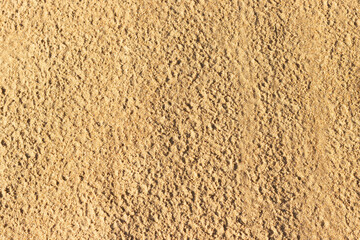 Uneven surface of sand on the beach at the seaside on a sunny day.