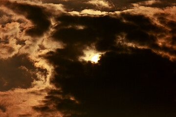 The yellow sun is hiding in the dark clouds