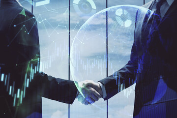 Double exposure of forex graph hologram and handshake of two men. Stock market concept.