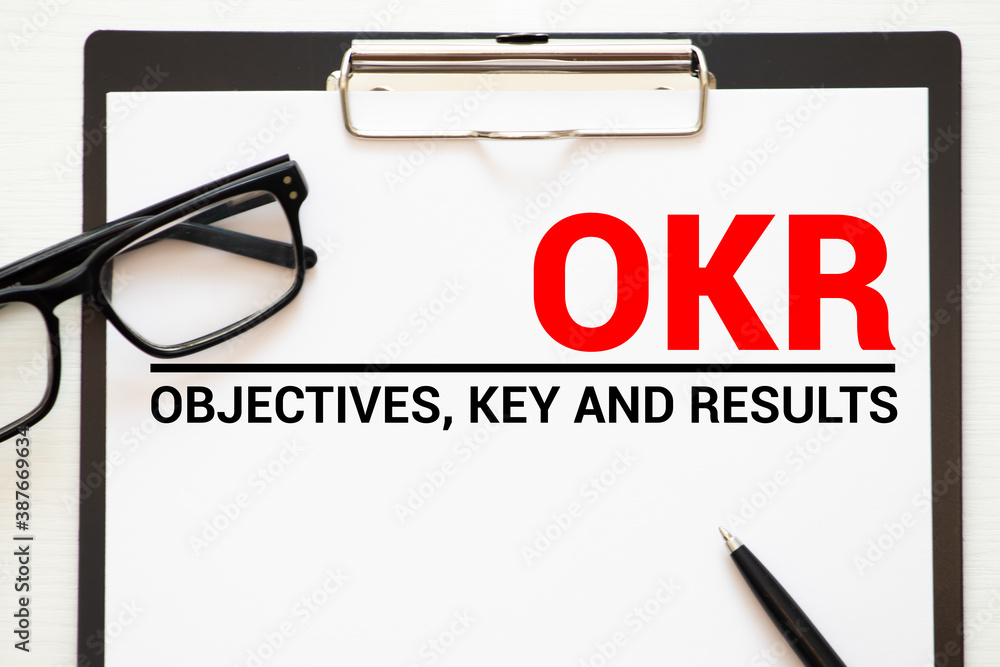 Poster objective key results text in the office notebook. view from above.
