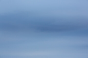 Overcast sky. Natural cloudy evening sky background. Blurred blue background. Great for design.