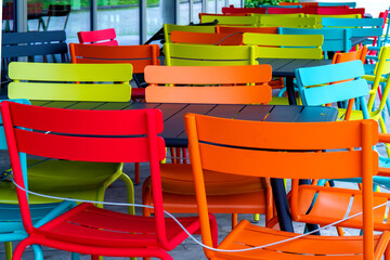 Deserted chairs and tables in front of a caf&eacute; which is closed due to a coronavirus