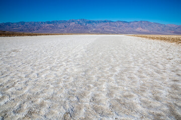 Fototapeta na wymiar The salt bed of Badwater Basin, the lowest point in North America at -282 feet, in Death Valley National Park in California.