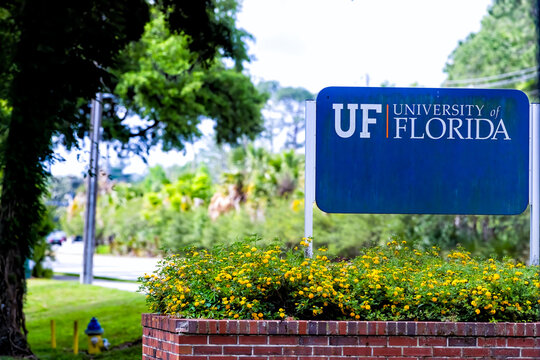 Gainesville, USA - April 27, 2018: Sign For Entrance To Campus Of UF University Of Florida In Central State With Nobody And Flower Decorations