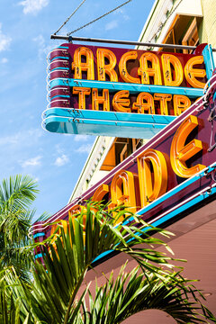 Fort Myers, USA - April 29, 2018: City street during sunny day in Florida gulf of mexico coast with retro vintage sign for Arcade theatre