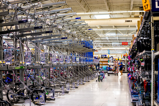 Sterling, USA - September 12, 2020: Walmart supermarket superstore shop interior inside with products goods aisle and empty shelves for bicycles bikes