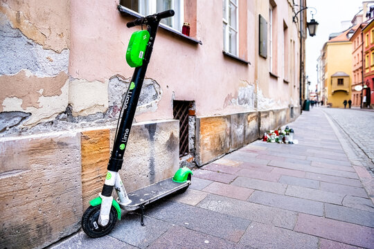 Warsaw, Poland - December 21, 2019: Lime electric scooter rental outside on street outdoors parked on street sidewalk in old town market square