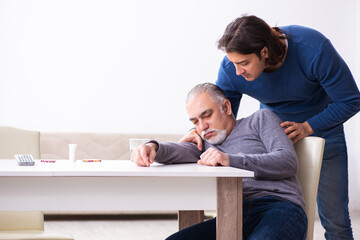 Grandfather and grandson in first aid concept