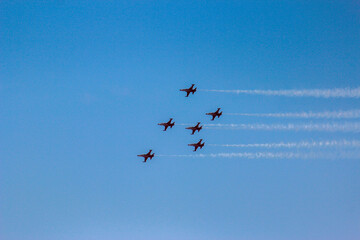 Airplanes flying in formation against blue sky 
