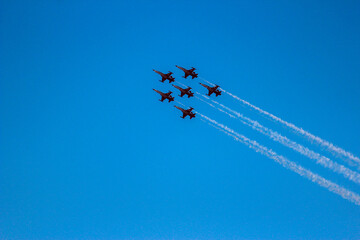 Airplanes flying in formation against blue sky 