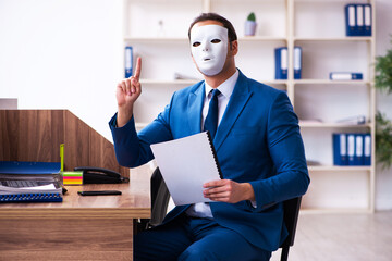 Young male employee wearing mask in the office