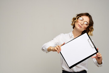 Naklejka premium Business woman in a light shirt and a folder with documents in hands cropped view of work