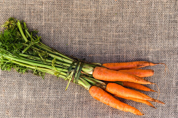 fresh organic carrots on jute background in Brazil