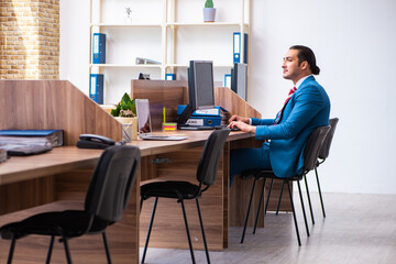 Young male employee working in the office