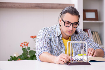 Young male student preparing for exam at home