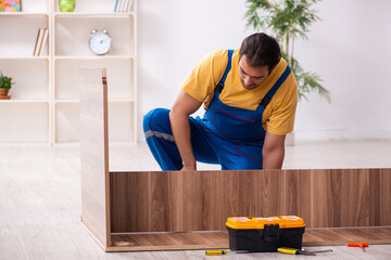 Young male carpenter working indoors