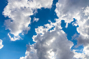 large puffy cumulus clouds bright blue sky