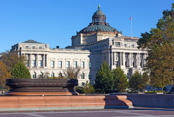 The west facade of the Thomas Jefferson Building of United States Library of Congress in autumn. The oldest of the four United States Library of Congress buildings under blue skies.