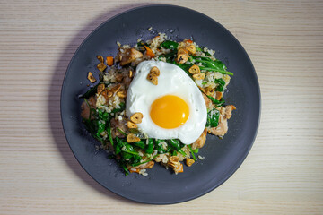 A plate of fried rice with sunny side up.