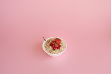 Oatmeal porridge with fresh frozen berries. Healthy breakfast.