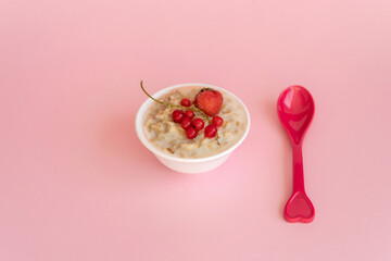 Oatmeal porridge with fresh frozen berries. Healthy breakfast.