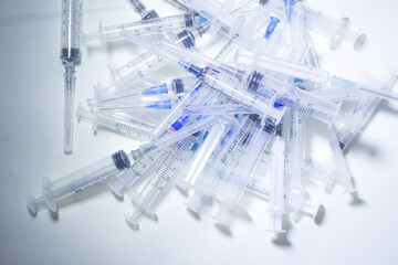 Many used syringes. Mass vaccination concept. Mass immunization. Anti-virus vaccine trials....
