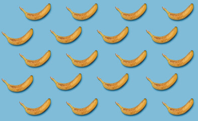 many yellow ripe bananas isolated on blue background pattern