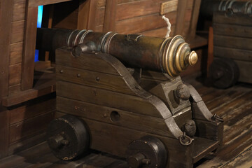 old cannon in wooden ship