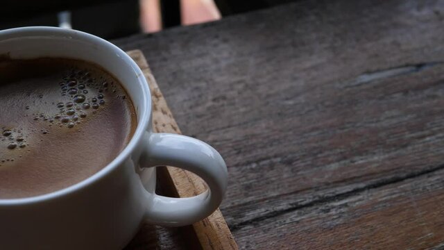 Cup of coffee close-up,Morning coffee,Black coffee on the wooden table in the morning