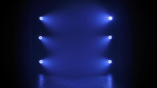 Stage blue floodlights flashing during a live show concert, in a night club or party. Dark background. Studio spotlight or projector motion template.