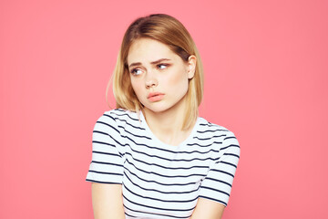 Fototapeta premium Woman in striped t-shirt emotions studio cropped view lifestyle pink isolated background