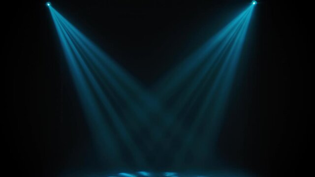 Concert lights. Lighting effects on a theater stage at night. Stage lights shine in the circus arena. Lighting equipment with blue beams.