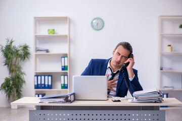 Sick male employee suffering at workplace