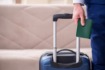 Young businessman holding passport preparing for trip