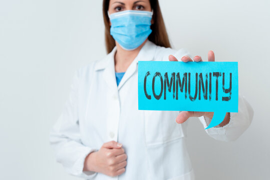Text sign showing Community. Business photo showcasing group of showing with a common characteristics living together Laboratory technician featuring empty sticker paper accessories smartphone