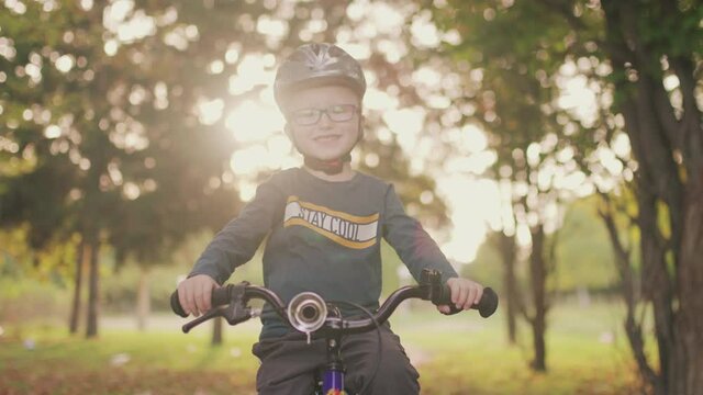 portrait of a four years old boy on a bicycle