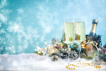 Champagne glasses and christmas decor on blue sparkling holiday background