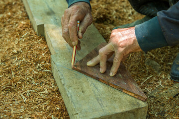 Carpenter working on woodworking machines.