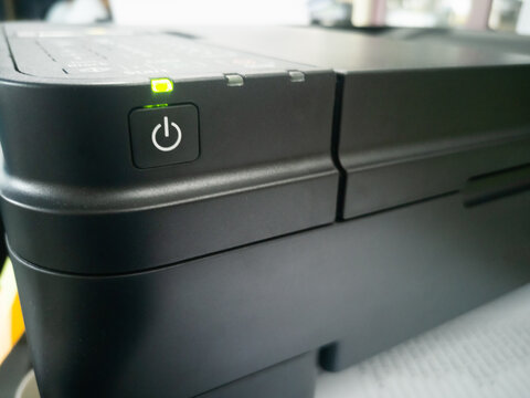 power button of printer with green color light. Hardware