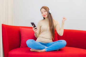 Portrait beautiful young asian woman listen music on sofa