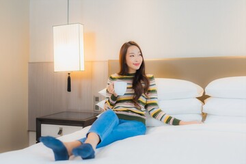 Portrait beautiful young asian woman smile happy relax on bed