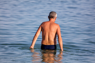 A man bathes in the water